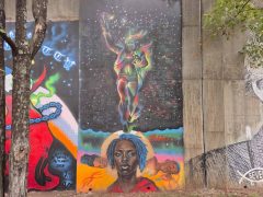 Street Art Mural in Cabbagetown Atlanta by Fabian Williams featuring Dr. Martin Luther King Jr., children sleeping, and a face