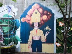 Street Art Mural in Cabbagetown Atlanta by Melanie Paulos featuring a woman with a house on her head