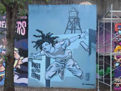 Street Art Mural in Cabbagetown Atlanta by SEVEN (Eric Finley) featuring a man floating in space