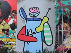 Street Art Mural in Cabbagetown Atlanta by Yoyo Ferro featuring a flower pot with a phone