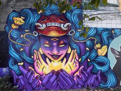 Street Art Mural in Cabbagetown Atlanta by Chris Alvarez and Courtney Hicks featuring a woman with a mask above her face